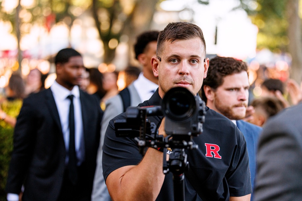 Adam Obirek filming on the sideline with a cinema camera